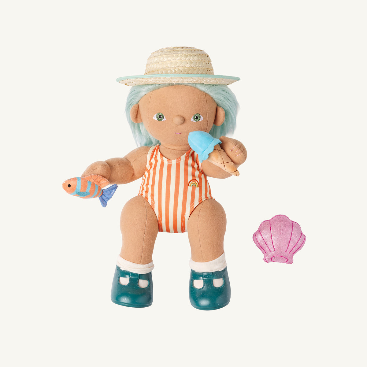 A dinkum doll with light blue hair wearing a straw hat, an orange and white striped swimsuit, and teal shoes, holding a small fish and ice cream cone, with a pink seashell accessory on a light cream background.