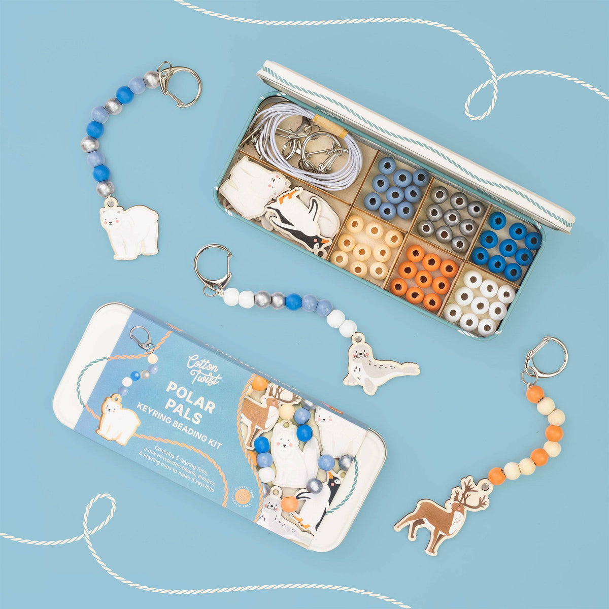A Cotton Twist children's bead keyring beading kit with polar bear and polar fox charms, shown with its storage box and packaging on a light blue background.