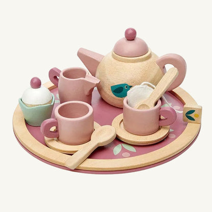 Children's toy tea set with pink teapot, cups, and saucers on a wooden tray.