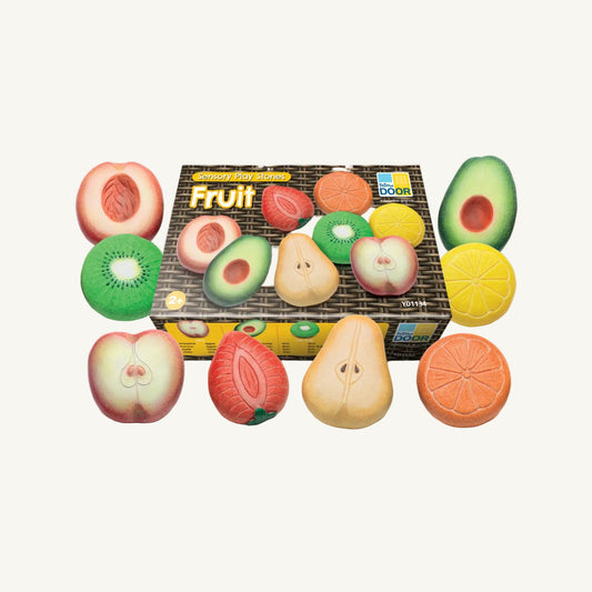 A box of Yellow Door fruit sensory play stones on an off white background