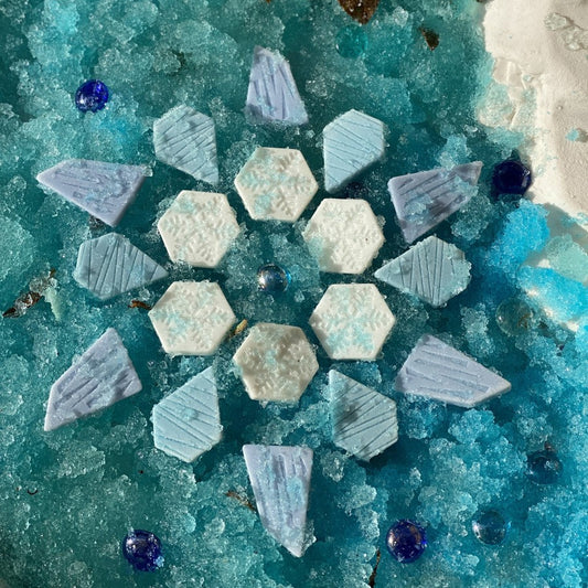 Geometric ice sensory stone pattern on a blue textured surface with a white spherical object.