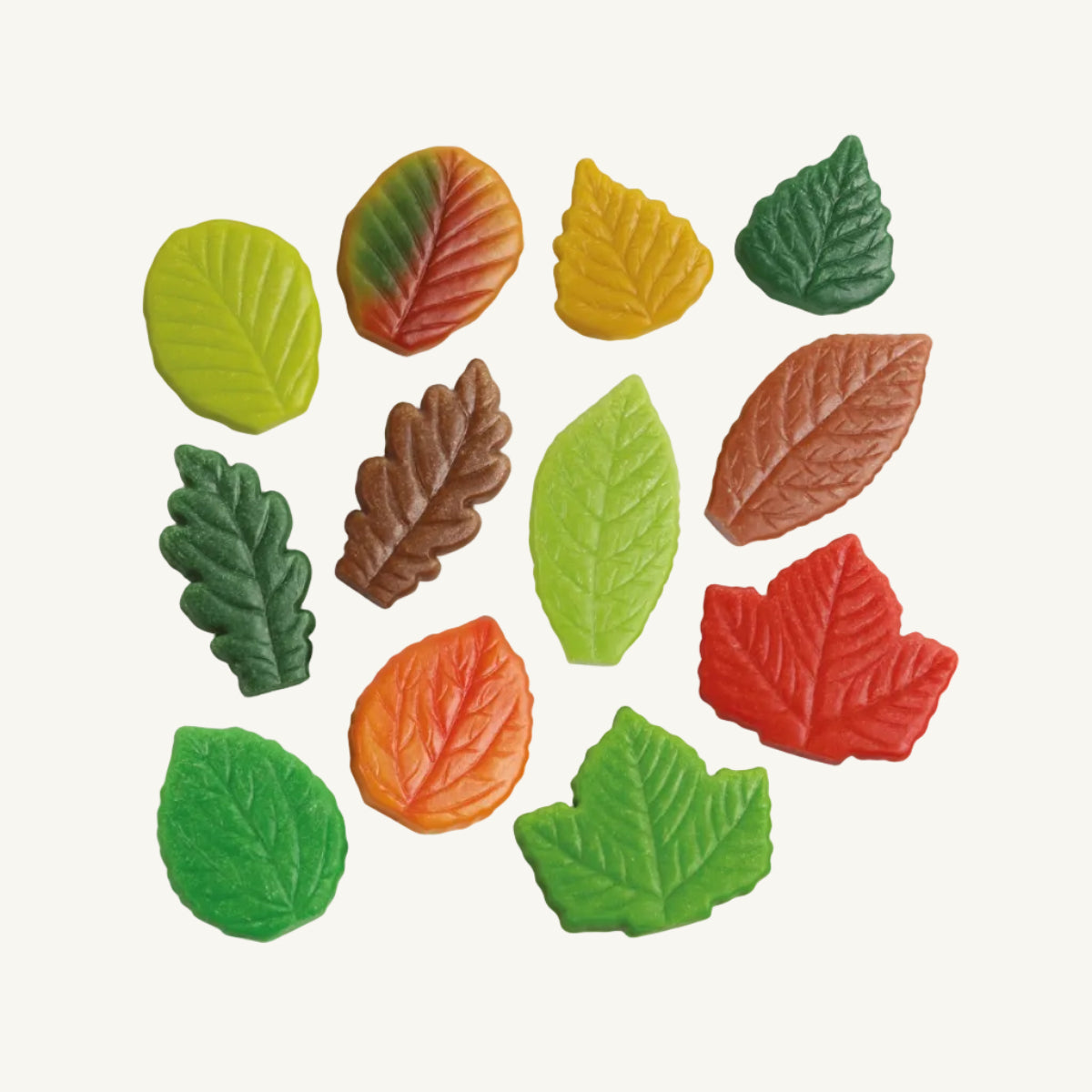 A set of colorful, leaf-shaped sensory stones in various autumn colors including green, yellow, orange, red, and brown, arranged on a plain white background.