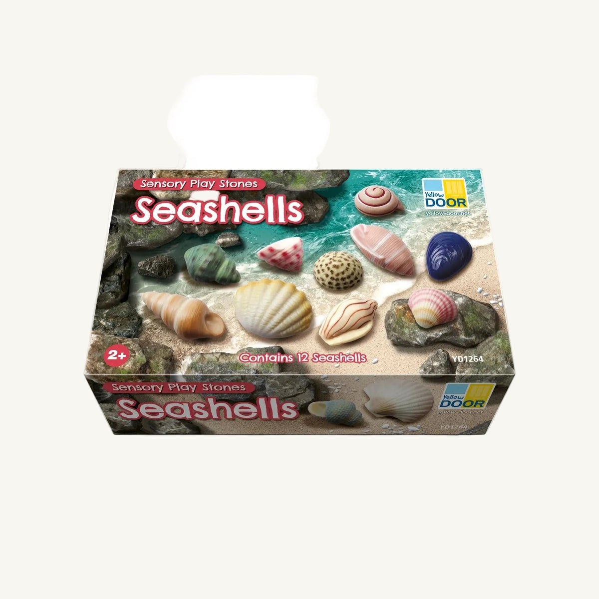 A box of Sensory Play Stones Seashells by Yellow Door, featuring an illustration of various colorful seashells on a sandy beach background.