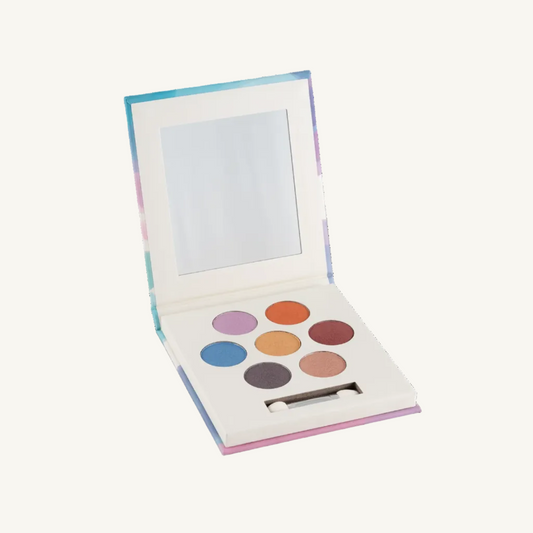 An open Namaki eyeshadow palette with a mirror in the lid and eight circular eyeshadow pans in assorted pastel and neutral shades, set against a plain white background.