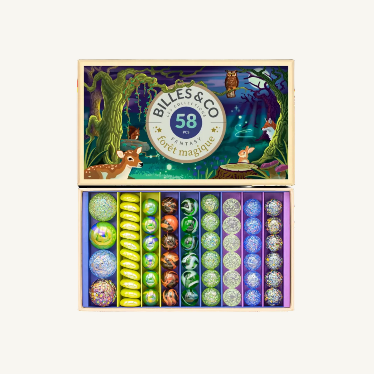 An open gift box filled with colorful round marbles, shown against a plain background. The lid features a whimsical forest illustration with a deer, owl, fox, and rabbit, and the brand name 'BILLES & CO' is visible in the center.