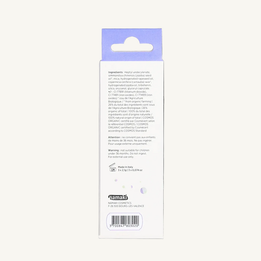 The back of a Namaki make-up crayon box with a light purple hanging tab at the top, photographed on a plain white background. Visible text includes ingredients, warnings, and the brand name Namaki at the bottom.