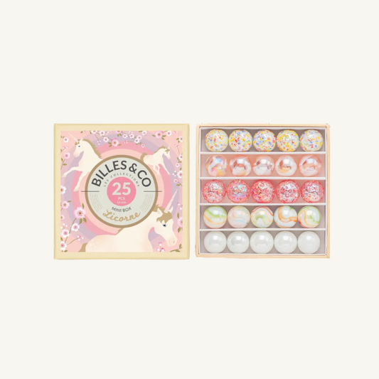 Billes & Co Unicorn Mini Box containing 25 mini marbles in various colors and patterns, shown next to its illustrated pink and cream unicorn-themed packaging box.