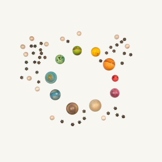 Colorful model of Grapat wooden planets arranged in a circular pattern on a white background