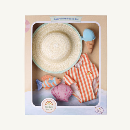 Dinkum Dolls Boardwalk Beach Set toy set in its original packaging, featuring a woven straw hat, orange and white striped swimsuit, pink seashell, and small toy fish on a cardboard display box.