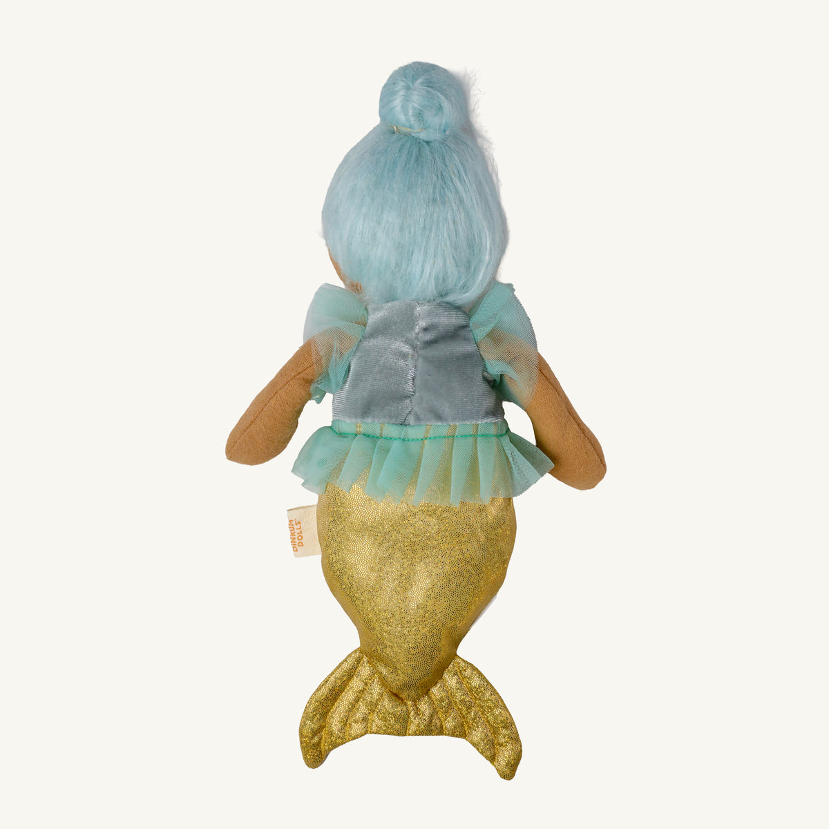 A plush mermaid doll shown from the back, featuring light blue hair in a bun, a gray-blue top with sheer mint sleeves, and a glittery gold tail, photographed against a plain off-white background.