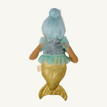 A plush mermaid doll shown from the back, featuring light blue hair in a bun, a gray-blue top with sheer mint sleeves, and a glittery gold tail, photographed against a plain off-white background.