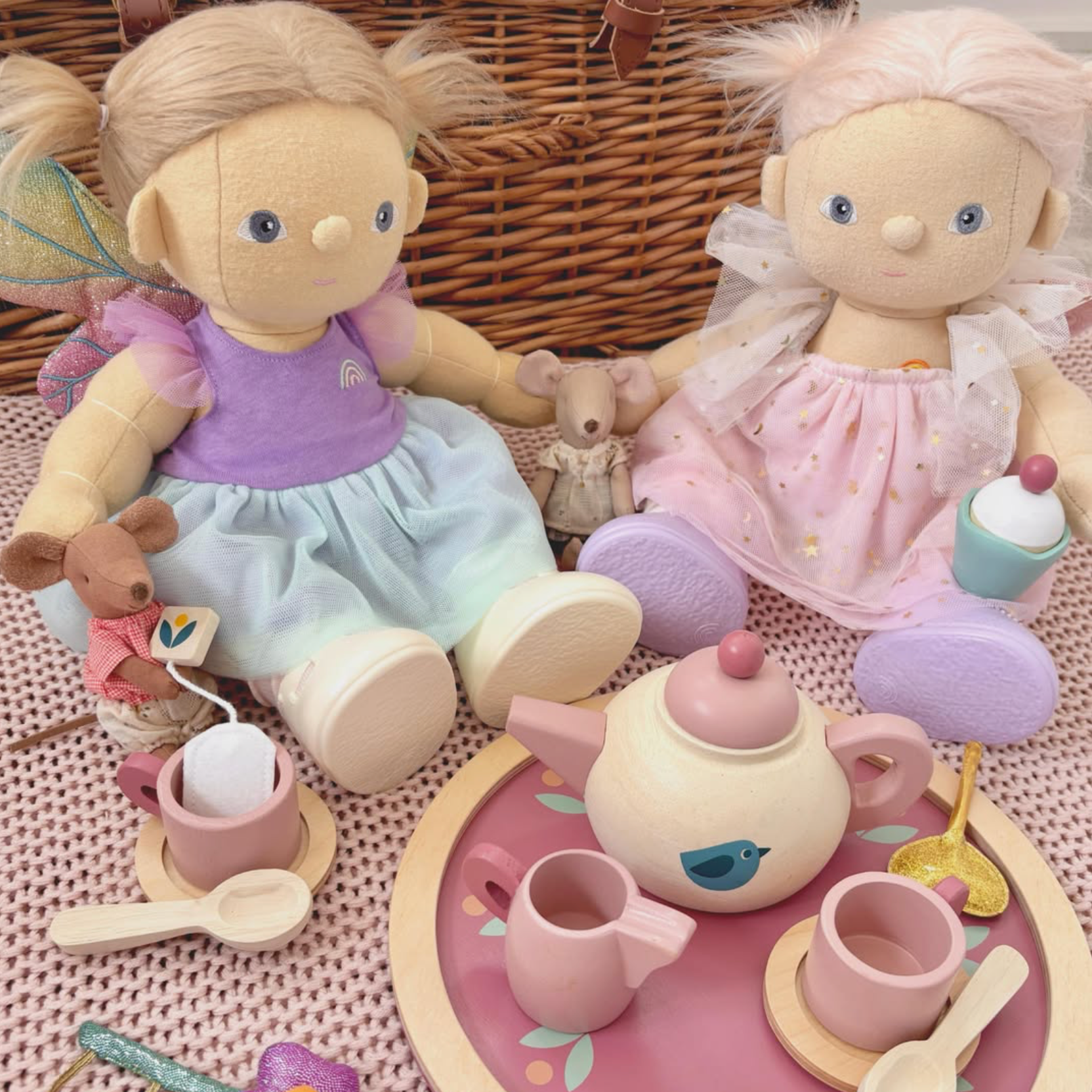 Two dolls with a tea set