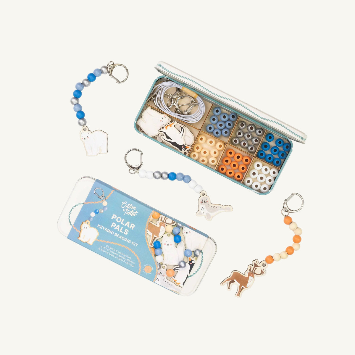 A children's bead keyring kit labeled 'Polar Pals Keyring Beading Kit' shown with its illustrated tin box and an open storage case on a white background. The kit includes blue and white beads, metal rings, small compartments with beads, and polar bear and polar fox charms.
