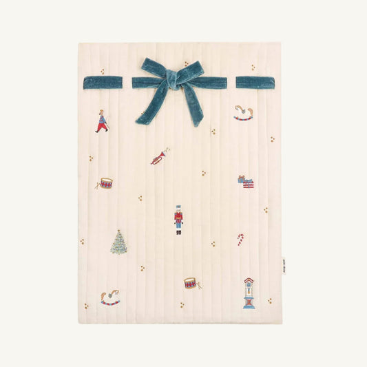 Nutcracker themed illustrations on a christmas sack from Avery Row with a blue ribbon on a white background