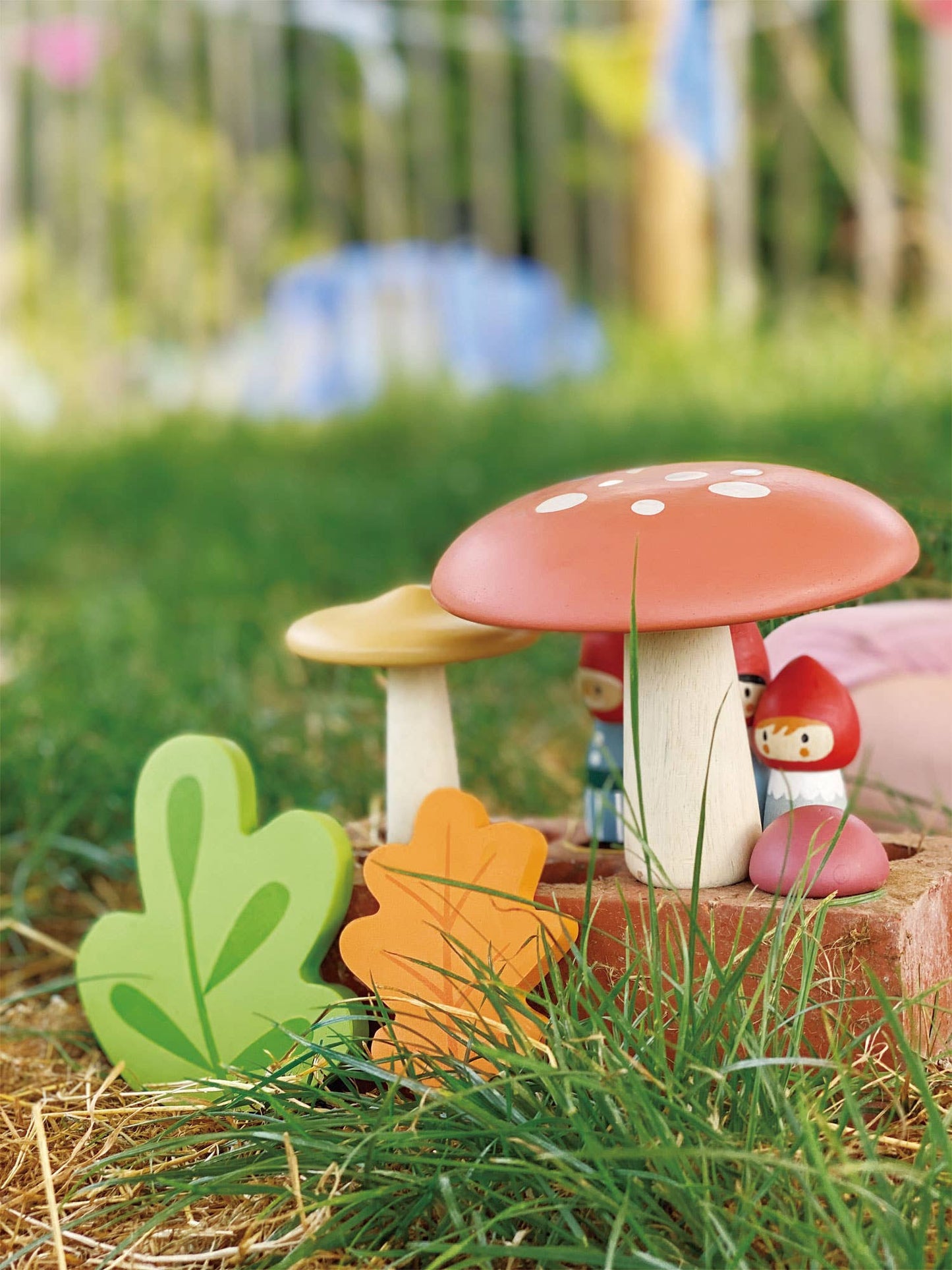 Decorative mushroom with a small gnome figure on a grassy background