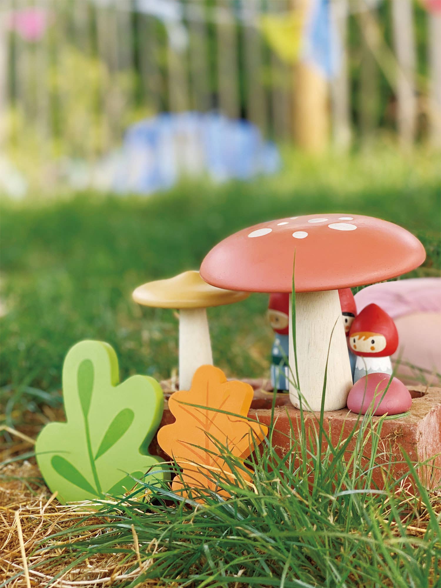 Decorative mushroom with a small gnome figure on a grassy background