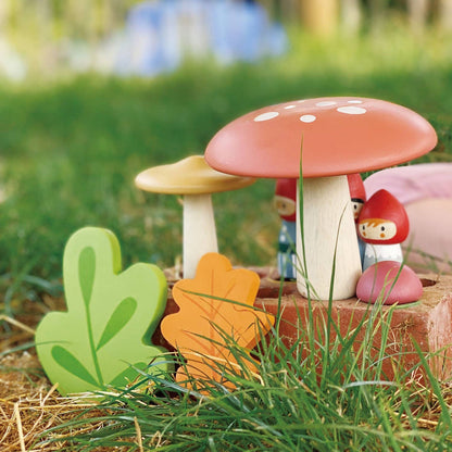 Decorative mushroom with a small gnome figure on a grassy background