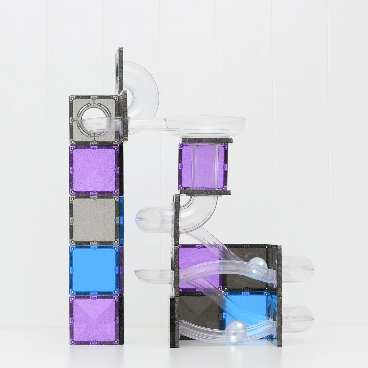 CONNETIX building tiles set with clear plastic tubes and tracks, featuring purple, blue, and gray square tiles on a white background.