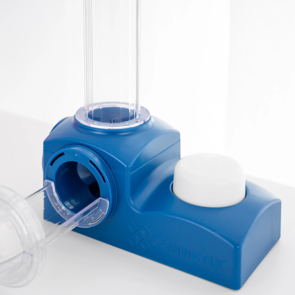 A blue ball run launcher device with a clear plastic tube and a white button shown on a white background.