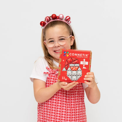 Girl holding a CONNETIX Magnetic tiles Christmas Santa Pack 